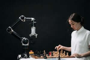 Picture of a woman playing chess with a robot, strategy, sound negotiator, ai.