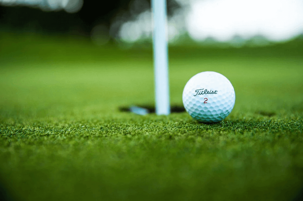 Close-up of golfball near pole